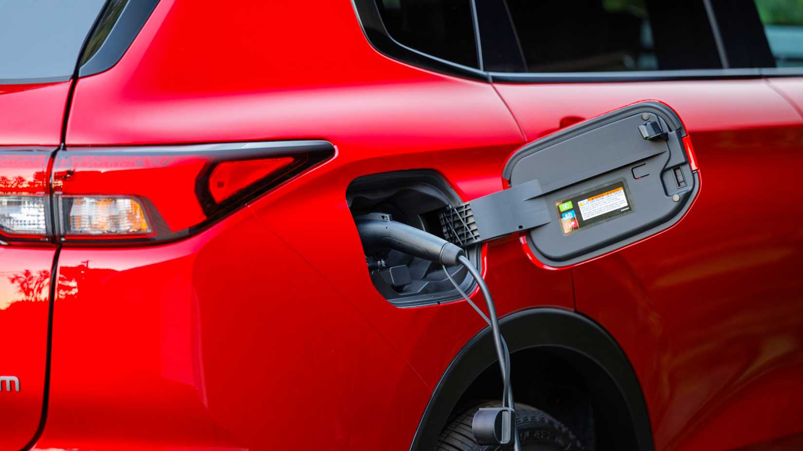 Rear-end shot of a 2026 Nissan Rogue PHEV charging