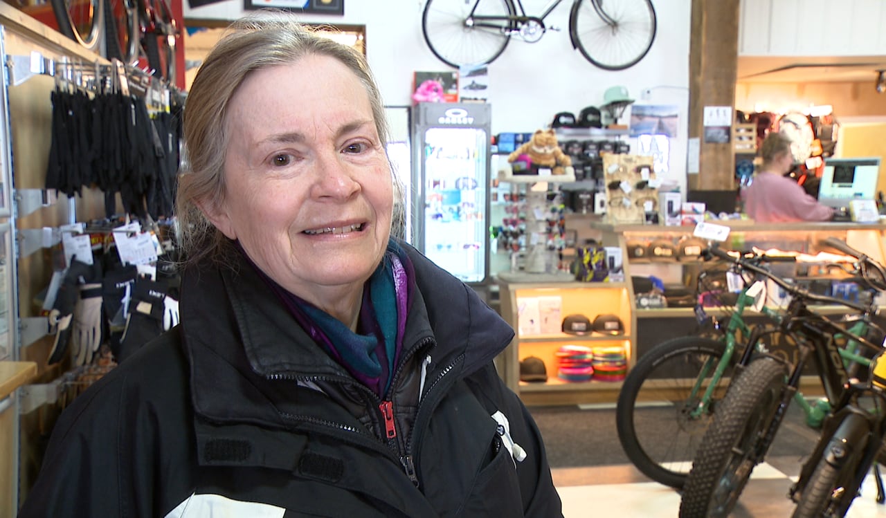 A woman standing in a bike shop