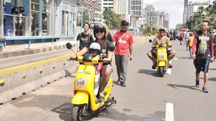 People ride Migo electric bikes during a Car Free Day event on Dec. 30, 2018, near the Hotel Indonesia traffic circle in Central Jakarta.