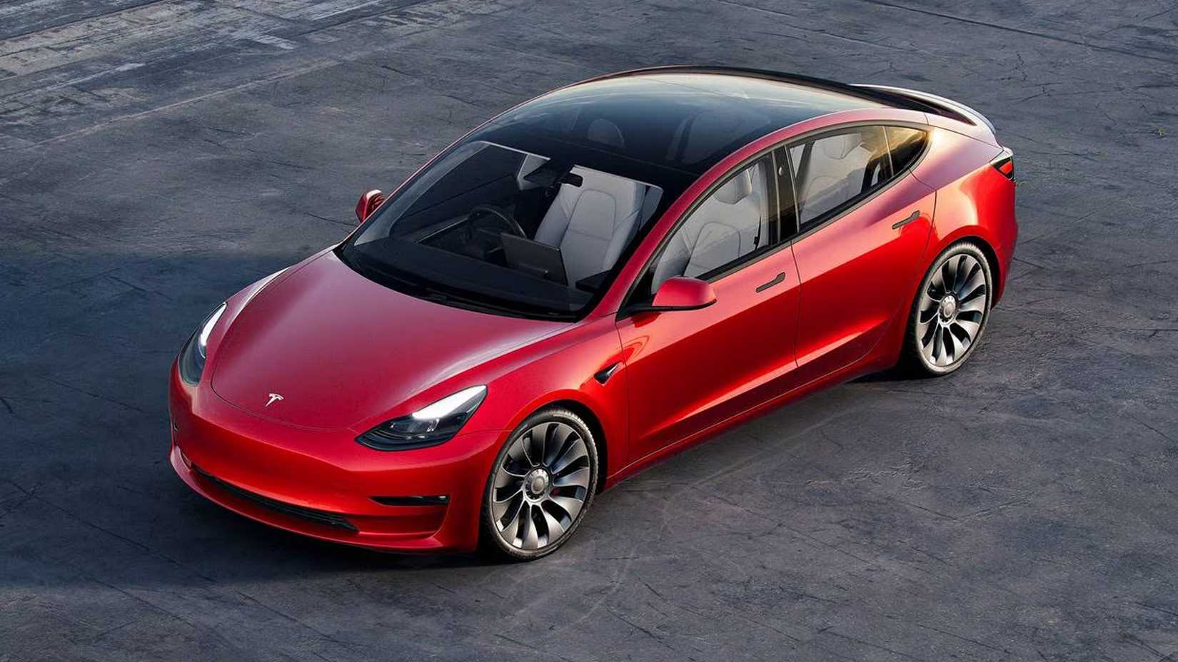 red 2023 Tesla Model 3 Performance parked