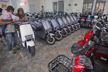 A consumer inspects an electric motorcycle showcased on March 6, 2023, in the Tangkas Ciater electric motorcycle showroom in South Tangerang, Banten.