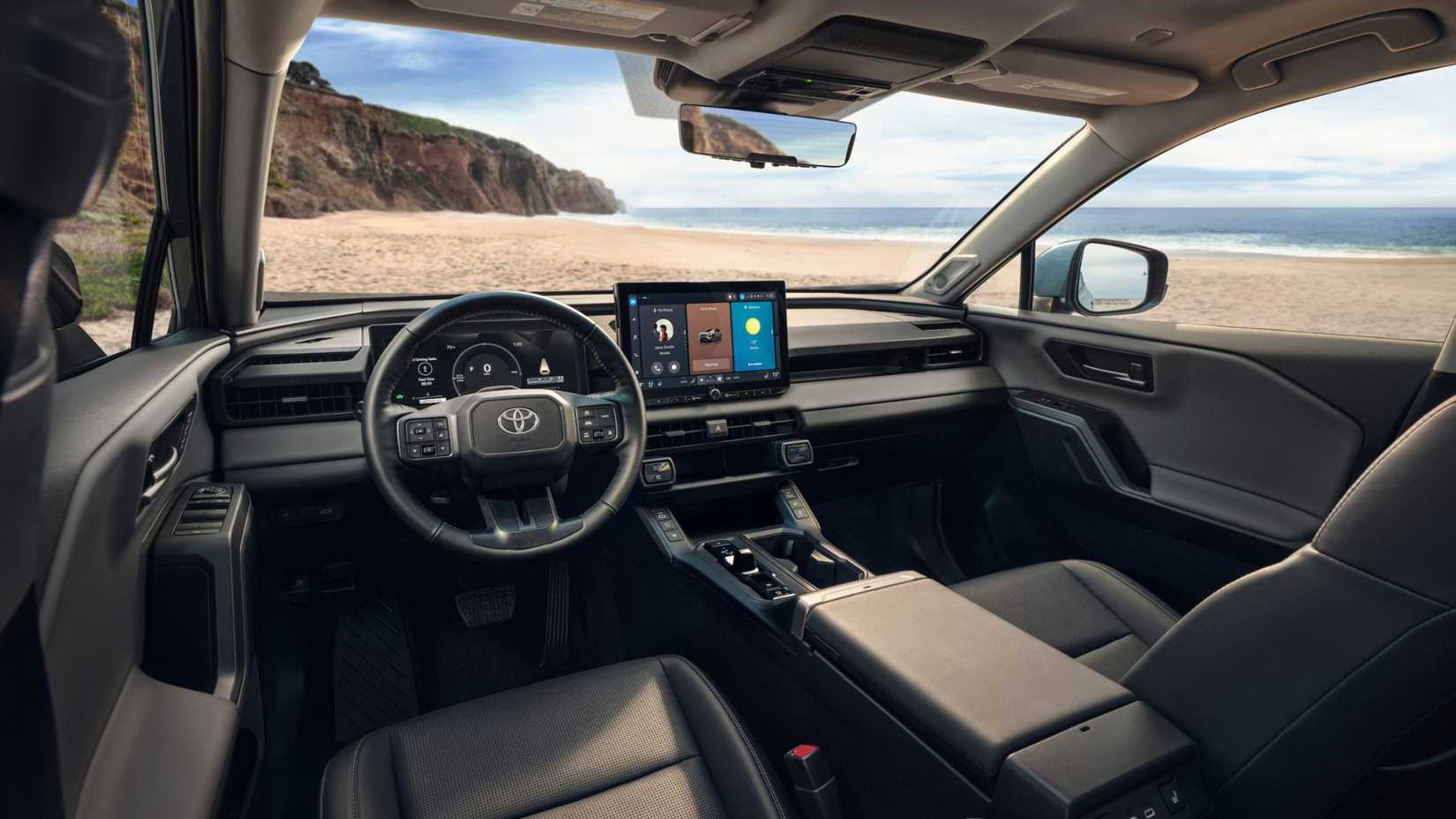 Shot of the cabin of the 2026 Toyota RAV4 Limited showing the front seats, steering wheel, and infotainment screen.