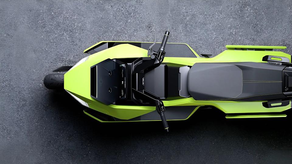Top view of a lime green and black electric motorcycle with a digital display and black seat on asphalt.