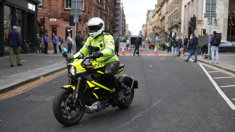 GLASGOW, SCOTLAND - NOVEMBER 05: A police officer on an electric motorcycle escorts the 