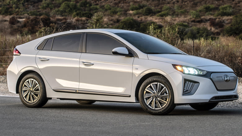 A white 2021 Hyundai Ioniq Electric in front of a hill.