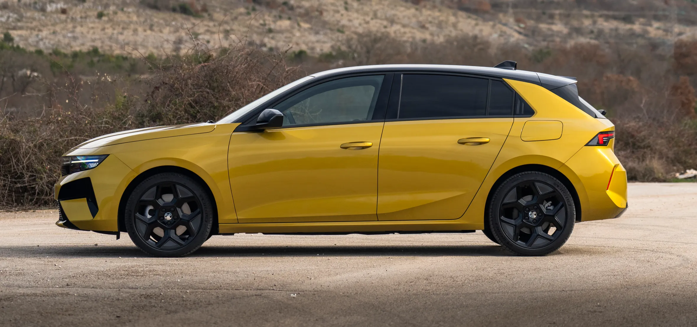 2026 Vauxhall Astra Hatch parked on a paved surface with a mountain landscape in the background.