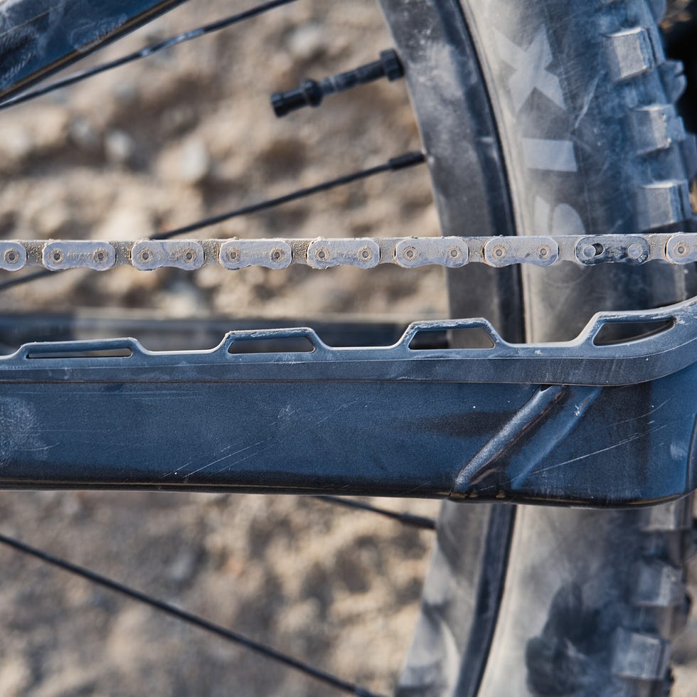 Close-up of a bicycle chain on a mountain bike frame.