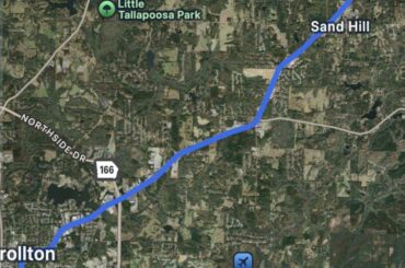 A map showing a route marked in blue from Carrollton to Sand Hill in Georgia. The map displays roads, greenery, and landmarks like Little Tallapoosa Park.