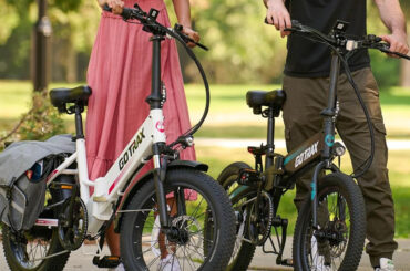 A man and woman standing next to bicycles