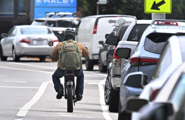A rider on a electric bike travels on Sir Francis Drake Boulevard in Kentfield, Calif., on Wednesday, March 26, 2025. (Sherry LaVars/Marin Independent Journal)