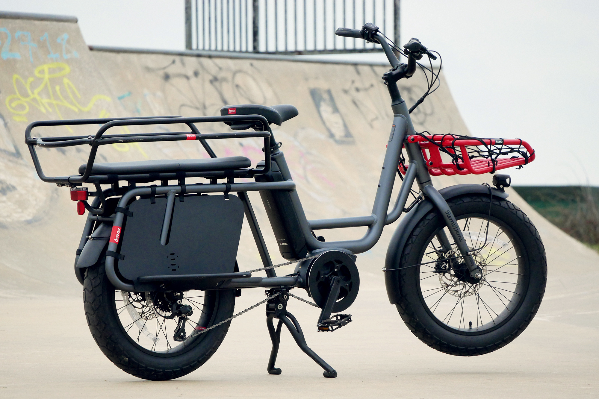 A wide shot of the Benno RemiDemi XL against the backdrop of a concrete skatepark