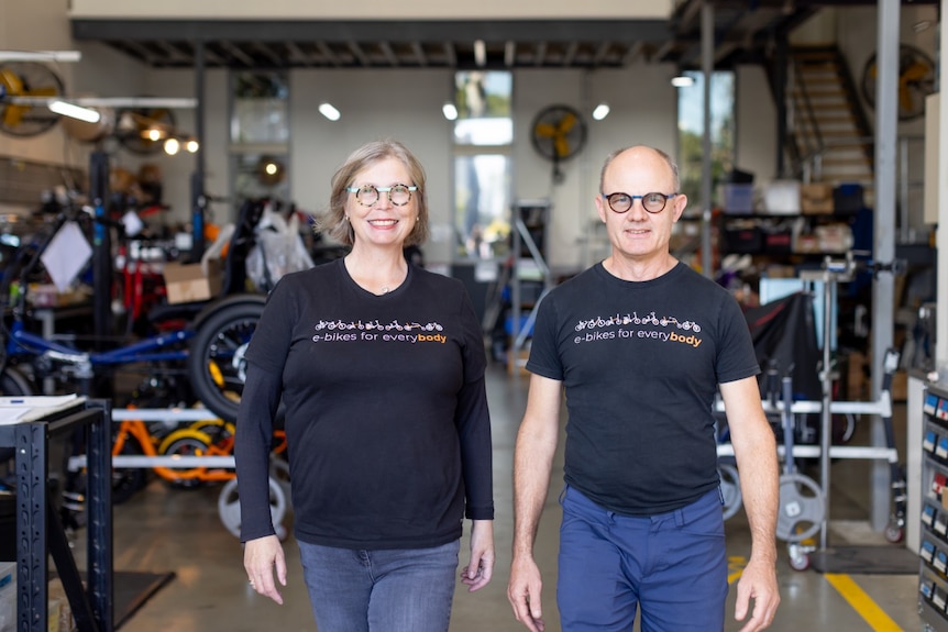 middle aged couple standing smiling at camera