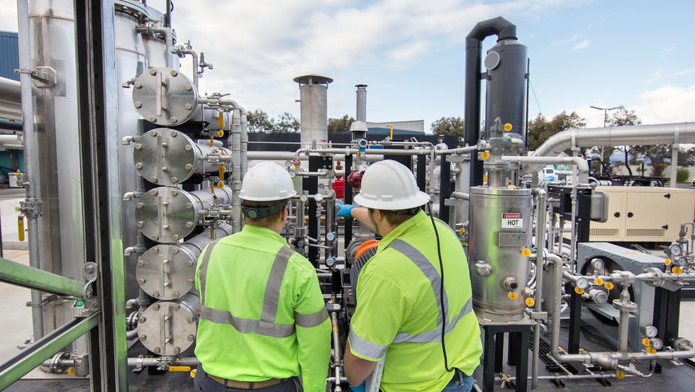 worker inspecting a solid waste processing plant