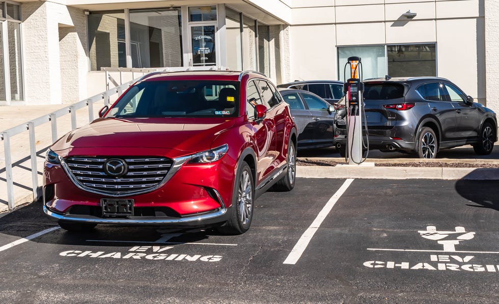 an electric mazda vehicle for sale at a dealership on a sunny winter day