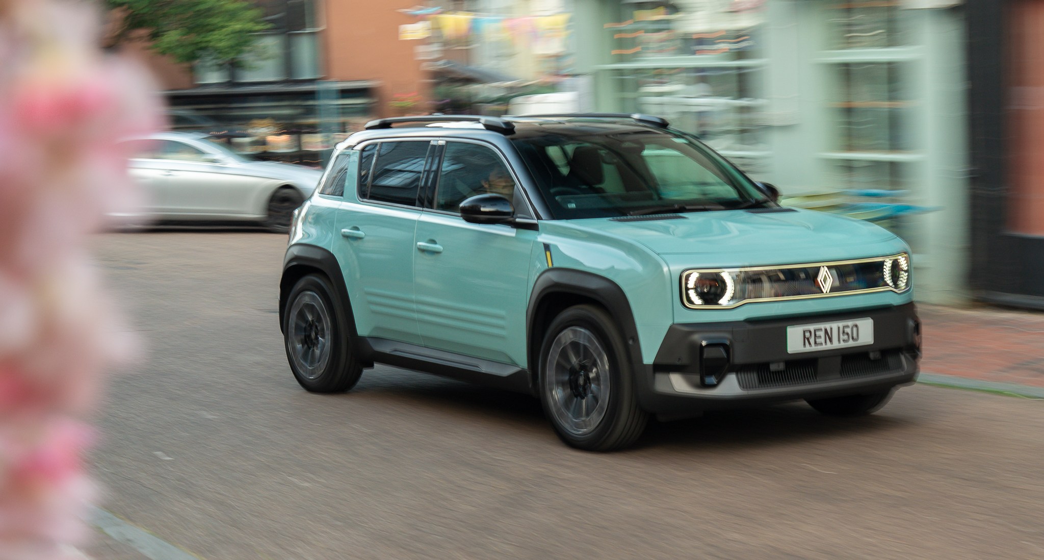 2025 Renault 4 E-Tech driving on a street.