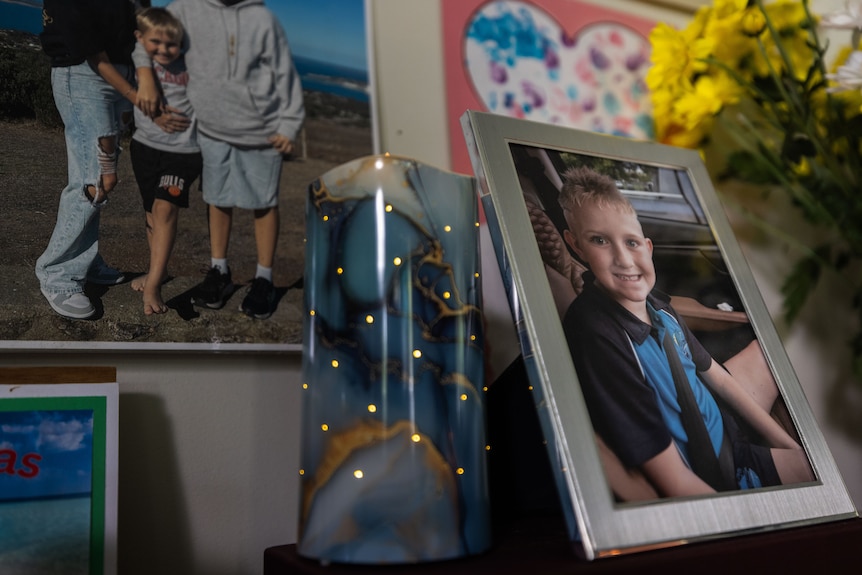 A photo of a young blonde boy on a mantle piece.