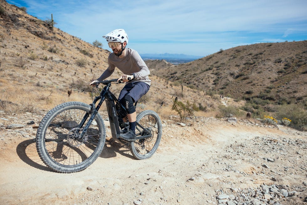 Mountain biking on a trail in a hilly area.