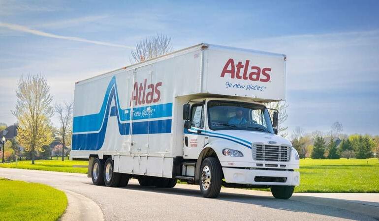 An Atlas Van Lines moving truck drives along a residential street. Photo: Atlas Van Lines / Used with Permission