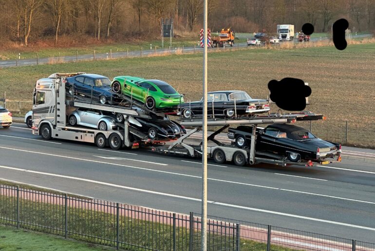 Not a great picture, but I spotted a very random [multi] collection of rare cars on a truck