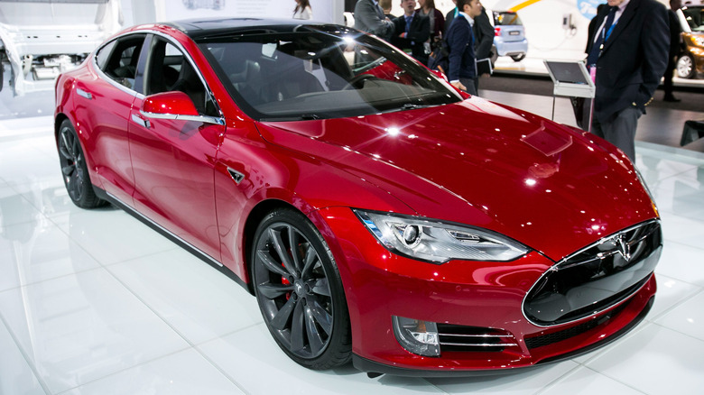 A red 2015 Tesla Model S P85D at a showcase