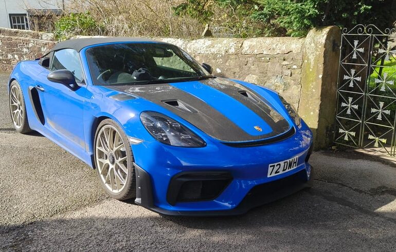 Shark Blue [718 Spyder RS] parked outside a church