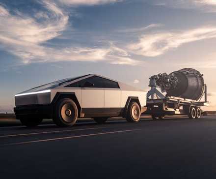 Exterior action shot of the Cybertruck towing a SpaceX raptor rocket.