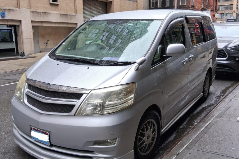 What appears to be a JDM [Toyota Alphard] with diplomatic plates