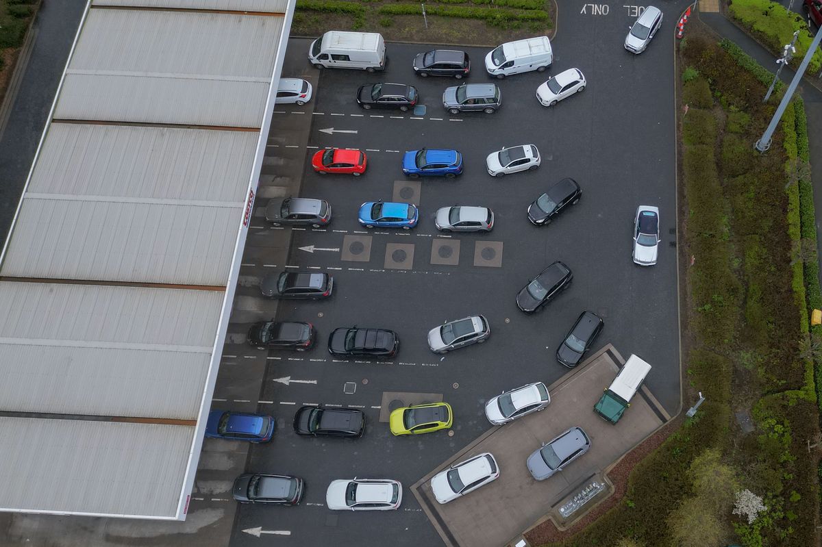 Drivers fill their cars at a Costco Petrol station in Derby