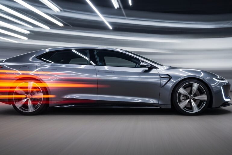 An abstract, colorful image created with a slow shutter speed and panning motion, depicting a futuristic electric vehicle as a blur of vibrant streaks, conveying a sense of speed and technological progress.
