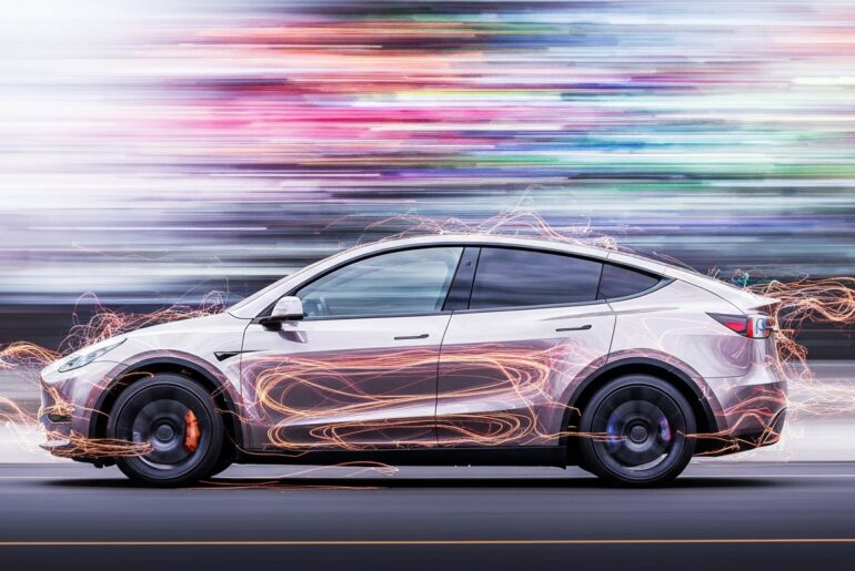 An abstract, blurred image of a Tesla electric vehicle in motion, with vibrant streaks of color and a sense of speed and modern engineering.