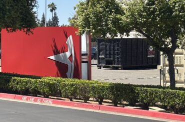 tesla t sign sitting sideways in a parking lot