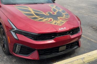 KIA with a Firebird decal on the hood... Official car of....