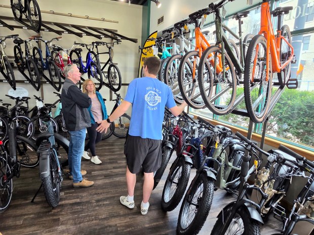 Marlene Rennwanz of Cary and her husband George check out e-bikes recently at Mill Race Cyclery in Geneva. (David Sharos/For The Beacon-News)