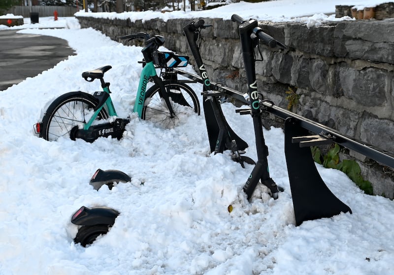 Rentable scooters and bikes from the Syracuse bike-share program remain buried after a substantial snowfall overnight. Tuesday, Nov. 23, 2021. (Katrina Tulloch | ktulloch@syracuse.com)