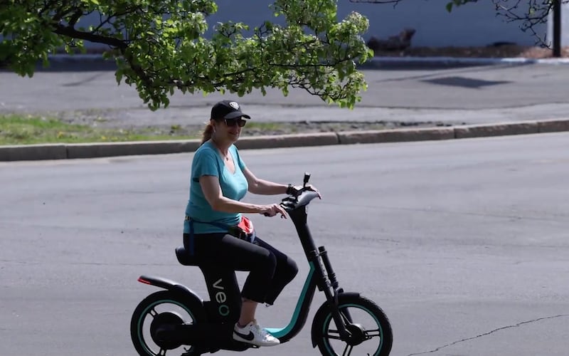 Syracuse.com sports reporter Donna Ditota rides a Veo e-bike in Syracuse in 2022.