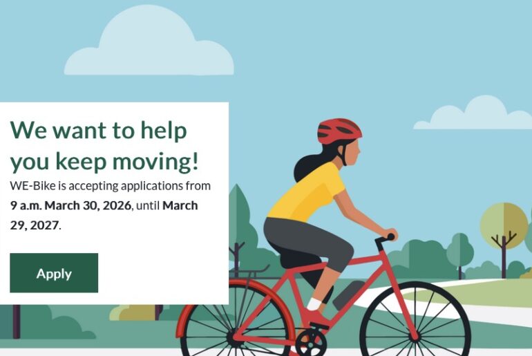 Illustration of a person riding an e-bike on a tree-lined path. Text: We want to help you keep moving! WE-Bike is accepting applications from 9 am March 30, 2026 until March 29, 2027.