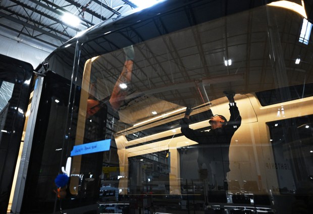 Employees work on hanging ceiling panels in an electric camp trailer made by Lightship RV at the company's manufacturing facility in Broomfield, Colorado, on March 3, 2026. (Photo by RJ Sangosti/The Denver Post)
