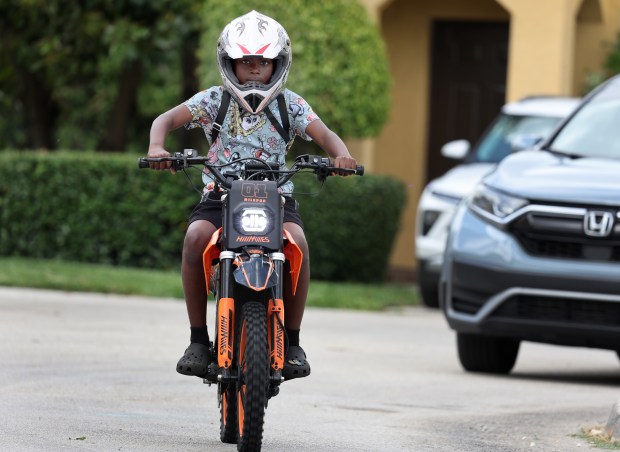 Varren Lacoste, 11, of Miramar, rides his e-bike on Friday, April 3, 2026. (Carline Jean/South Florida Sun Sentinel)