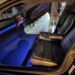 A view of the Tesla Cybercab robotaxi interior and ambient lighting (blue). This is an early production engineering test and display unit on display in Austin, Texas.