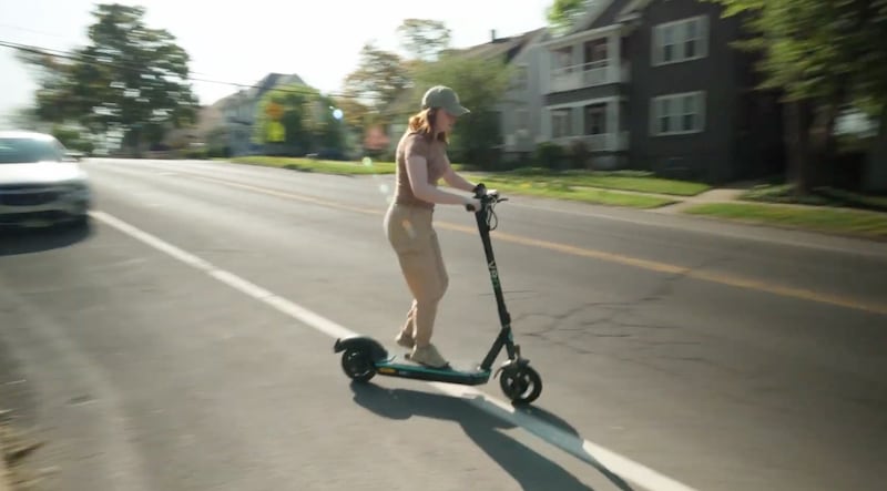 Syracuse.com reporter Anne Hayes rides a Veo scooter in 2022.
