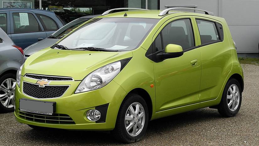 A parked Chevy Spark in green color