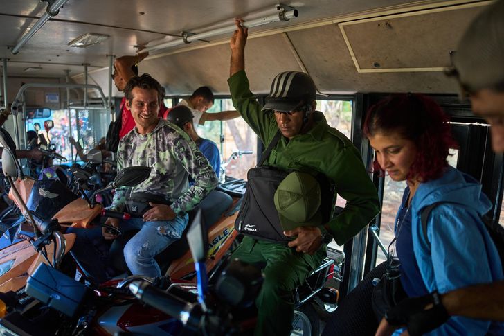 People and their bicycles and motorcycles cross the Bay Tunnel in a public bus in Havana, Wednesday, April 8. AP-Yonhap