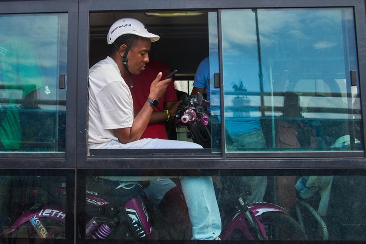 A man sits on an electric bicycle on a public bus to cross the Bay Tunnel in Havana, Wednesday, April 8. AP-Yonhap