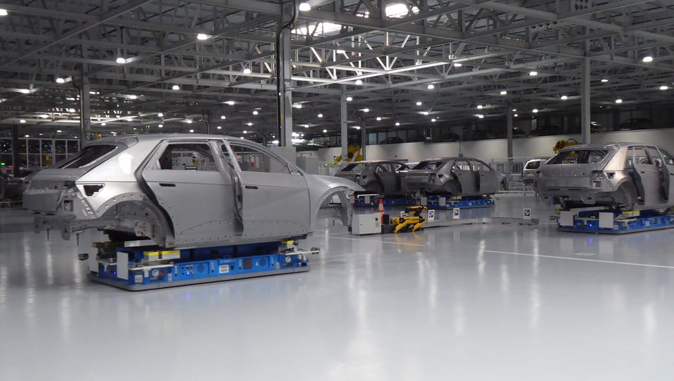 car assembly line with multiple car frames on automated platforms