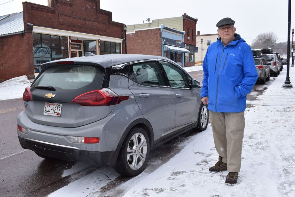 George Bussey, who lives south of Ashland, poses with his Chevy Bolt. He’s one of the Wisconsin EV drivers benefiting from the DOT’s focus on the EV infrastructure in the northern part of the state. Danielle Kaeding/WPR
