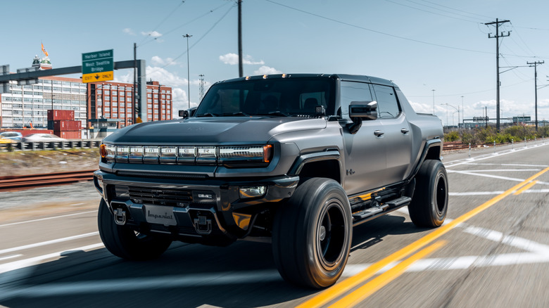 blacked out Hummer EV driving on the road