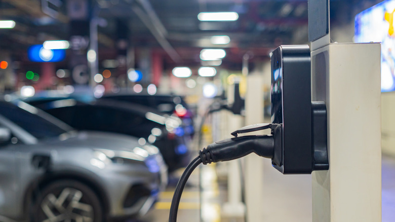 electric vehicles charging at stations in a parking garage