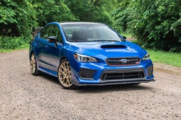 What song is this WRX with a giant subwoofer and these specific bumper stickers blasting?