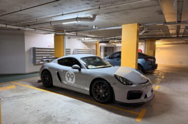 [Porsche Cayman 981 GT4] at building's visitor parking