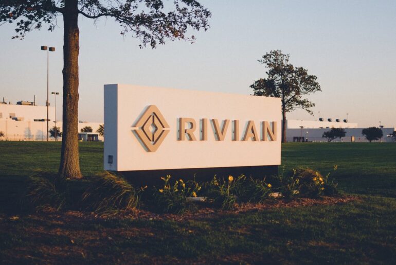 A building with the Rivian logo sign on front lawn.